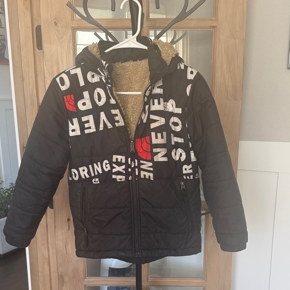 The North Face Black Puffer Jacket with White Text and Red Logo
